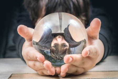 Reflection of a boy in a glass bowl. Abstract portrait.の写真素材