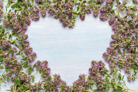 flowering oregano on a wooden table. Place for textの写真素材