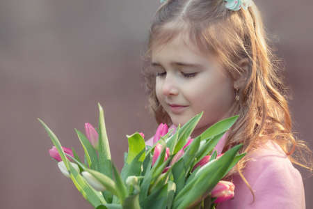 Girl with a bouquet of tulipsの写真素材
