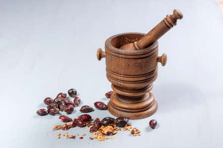 pile of dry rose hips on a wooden tableの写真素材