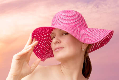 Portrait of a middle-aged woman in a pink hatの写真素材