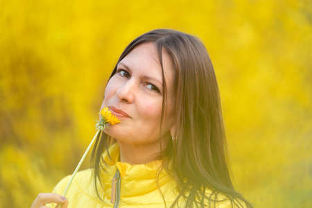Portrait of a middle aged woman with dandelionの写真素材