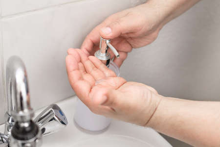 Man washes his hands with soapの写真素材