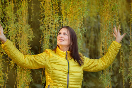 Portrait of a middle aged woman in yellow clothes