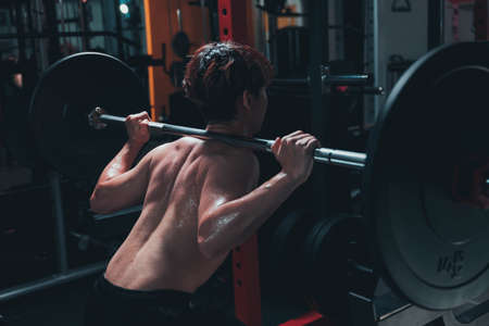 Man doing squat in the gymの写真素材