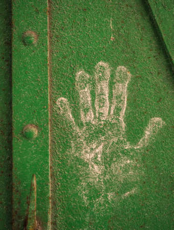 In Porto Vecchio of Triest a white hand on a old metal door.の写真素材