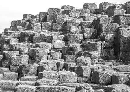 BUSHMILLS, NORTHER IRELAND - JULY 13, 2016 Giant's Causeway. Sixty million years ago Antrim was subject to intense volcanic activity an this is the result of different volcanic activity, seems a stair.- Northern Irland on July 13, 2016のeditorial素材
