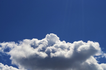 Light Blue sky with white clouds scattered throughout.の写真素材