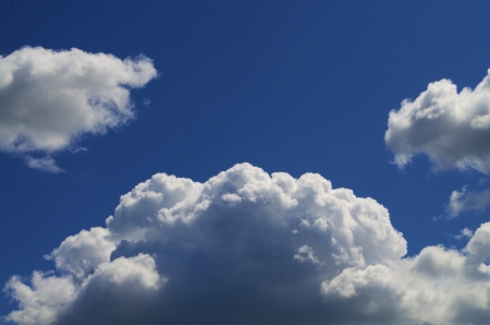 Light Blue sky with white clouds scattered throughout.の写真素材