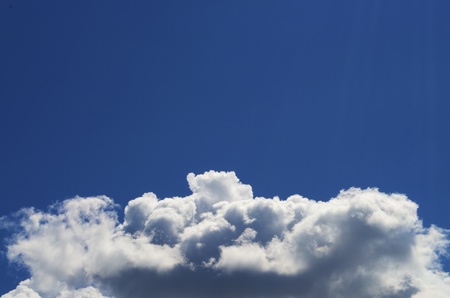 Light Blue sky with white clouds scattered throughout.の写真素材