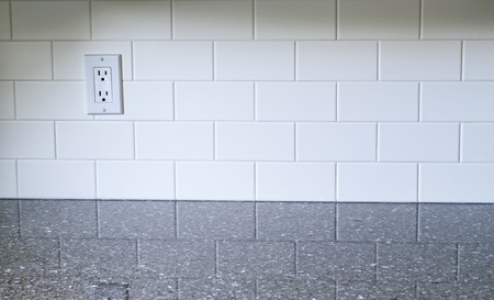 White Kitchen backsplash with a white outlet on the left side with quartz countertopの写真素材