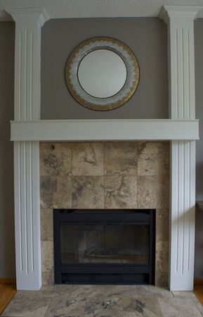 Black wood fireplace, white pillars and mantel with stone tileの写真素材
