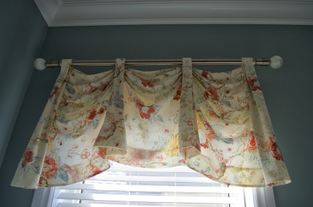 Close up view of a light colourful valance covering a window.の写真素材