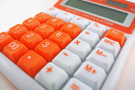 Calculator close-up shot focus on white backgroundの写真素材