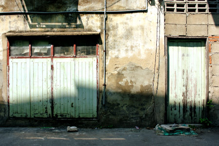 old vintage cracked wall with windows and doorのeditorial素材