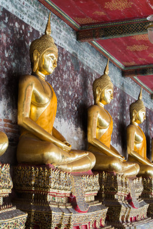 Golden Buddhist statues at Wat Suthat Temple in Bangkok, thailandのeditorial素材