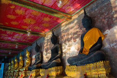 Golden Buddhist statues at Wat Suthat Temple in Bangkok, thailandのeditorial素材