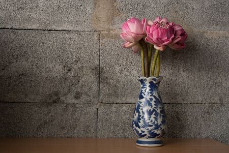 Bouquet of Pink Lotus on dark brick background, Dramatic lighting, Selective focus.の写真素材