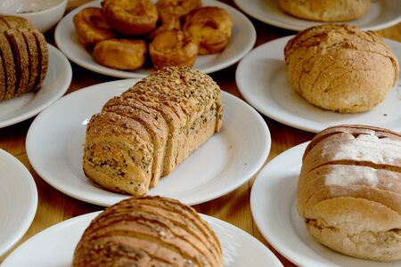 Baked bread on white plate and wooden table with Selective focus.の写真素材