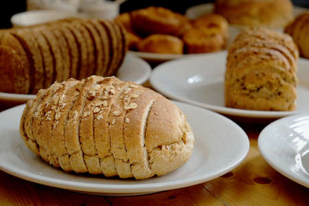 Baked bread on white plate and wooden table with Selective focus.