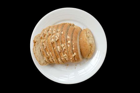 Baked bread on a white plate, Black Background isolated
