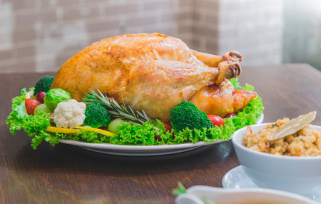Roasted turkey stuffing garnished with Vegetables served with gravy sauce on a rustic style table. Christmas Dinnerの写真素材