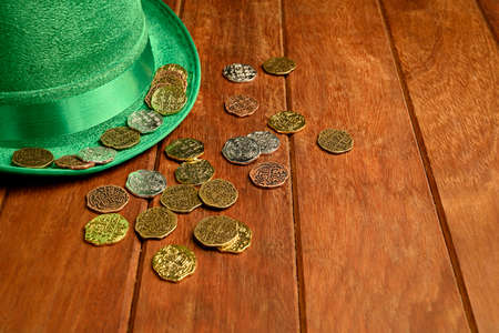 St. Patrick's concept. Green hat and lucky coins on black background.の写真素材