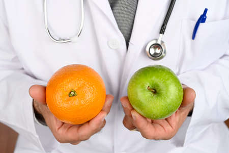 Health concept. Nutritionist doctor advises us to eat fruit. Healthy diet.の写真素材