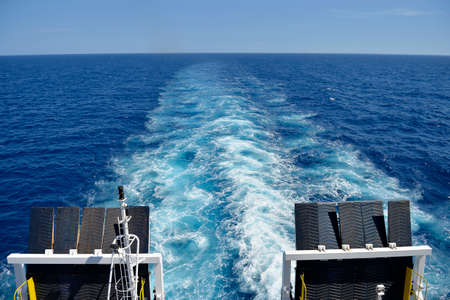Water trail foaming behind a ferry boat in Mediterraneanの写真素材