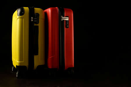 Two holiday suitcase prepared on black background, holiday concept, place for text.の写真素材