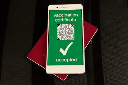 Vaccine passport for travellers. immunity e-passport in the smartphone mobile for travelling. 
The digital green pass of the european union with the QR code. Travel without restrictions.の写真素材