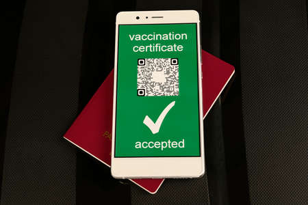 Vaccine passport for travellers. immunity e-passport in the smartphone mobile for travelling. 
The digital green pass of the european union with the QR code. Travel without restrictions.の写真素材