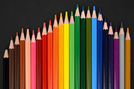 Crayons. Colored pencils on black cardboard background. Top view. Education concept. High quality photoの写真素材