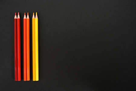 Crayons. warm colored pencils on black cardboard background. Top view place for text.
Education conceptの写真素材