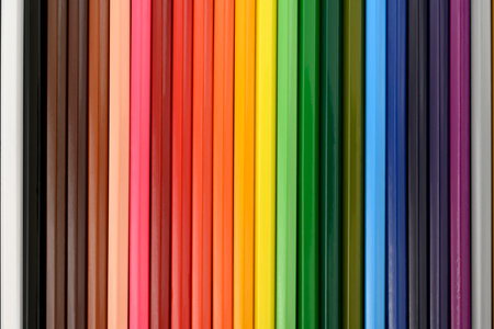 Colored pencils on a black cardboard background. Top view. Education concept. High-quality photoの写真素材