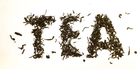 Word tea made from tea leaves on a white backgroundの写真素材