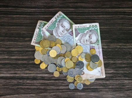 Money and a penny on the wooden backgroundの写真素材