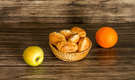 Fruits and croissants on a wooden backgroundの写真素材
