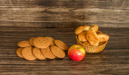 Cookies, apple and croissants on a wooden background .の写真素材