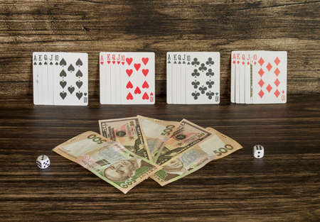 Cards and money on a wooden background