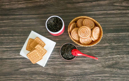 Tea, biscuits and a jar on a wooden background.の写真素材