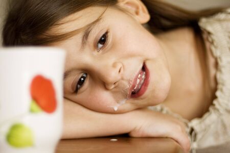 a little girl with a milk mustacheの写真素材