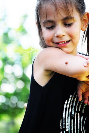 little girl with ladybirdの写真素材