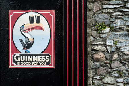 KILLARNEY IRELAND  14TH FEBRUARY 2015: Vintage Guinness sign outside traditional Irish pub in the town of Killarney Irelandのeditorial素材