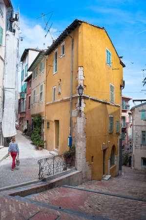 Walking through old cobblestone streets of villefranchesurmer on the French riviera.のeditorial素材