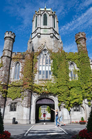 Tourists walking by the archway entrance of the Quadrangle building in Galway city University,のeditorial素材