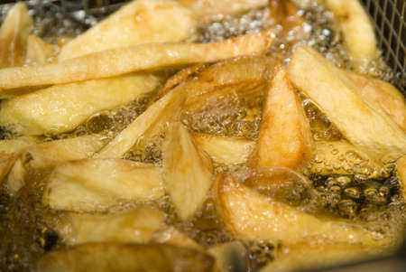 french fries cooking in hot oilの写真素材