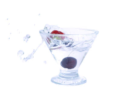 A glass with a cherry and a strawberryの写真素材
