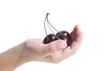Three cherries on a handの写真素材