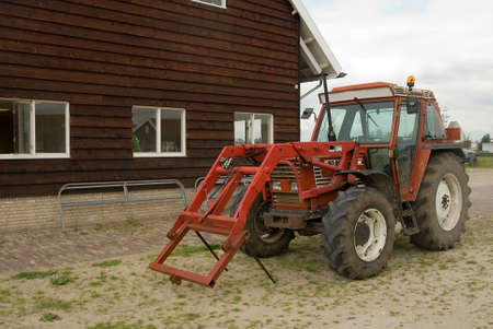 a tractor and an old barnの写真素材